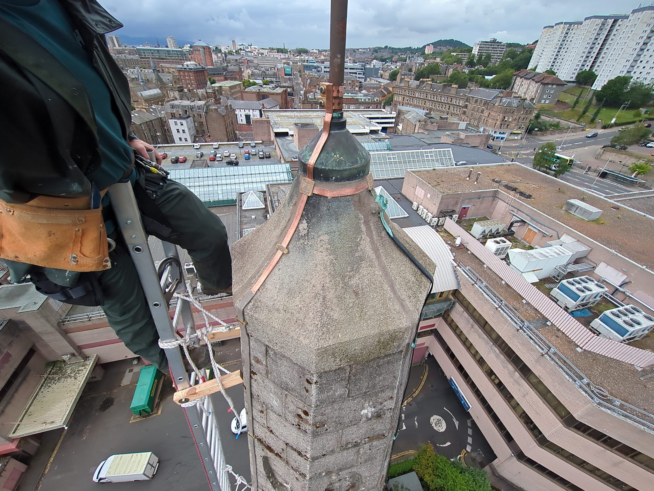 New copper lightning conductor tape installed on a church spire